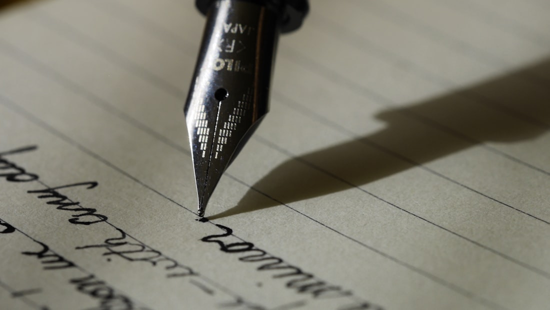 An open notebook and a workspace illustrating prompt-craft notes